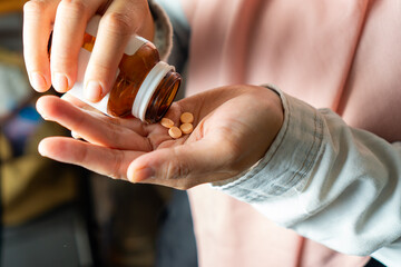 woman taking tablet of vitamin or supplement