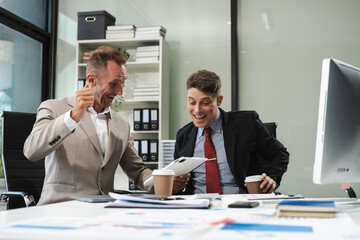 Businessmen caucasian, creative businesspeople coworker in office Happy to be successful partnership teamwork success concept.