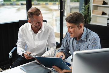 Caucasian business team working at office with laptop and documents on desk, financial adviser analyzing data.