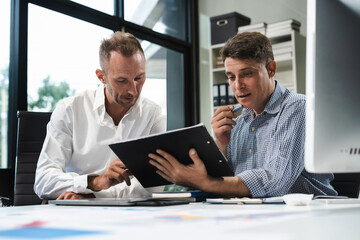 Caucasian business team working at office with laptop and documents on desk, financial adviser...