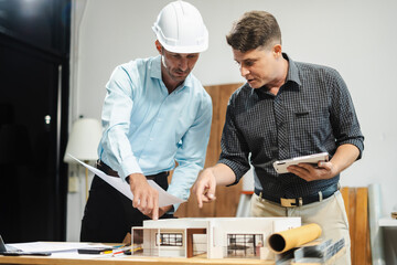 Architect caucasian man working, blueprint meeting for project working with partner on model...