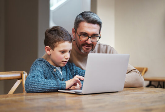 Laptop, education and dad with child in home for online learning, school project and lesson. Family, student and father teaching boy on computer for help with studying, homework and assignment