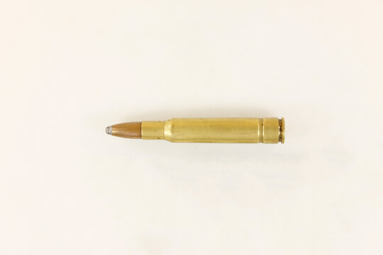 Rifle hunting cartridge of caliber 30-06 with an expansive bullet on a white background, close-up
