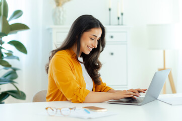 Online work. Positive pretty brunette arabian or indian young woman, IT specialist, product...
