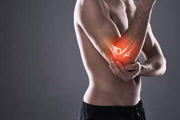 Man, elbow and injury of fitness in studio, anatomy of arm and xray for diagnosis. Red glow, mockup...