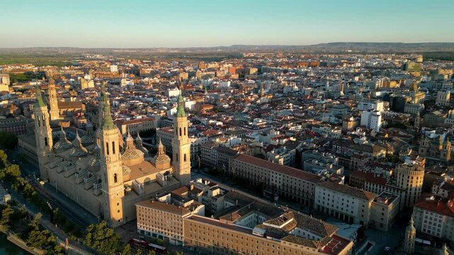 Rooftops of Zaragoza. Drone circling above the historic city center. Famous travel destination. View of Cathedral of Zaragoza, Plaza of Our Lady of the Pillar, River Ebro. Sunset point. Travel 