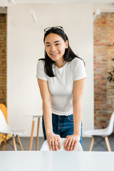 Vertical portrait of a young asian girl student marketing smm manager social media worker...