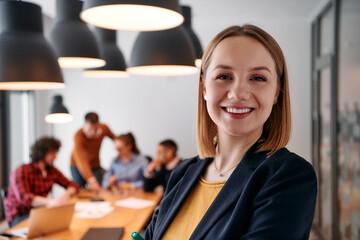 Confident Blonde Businesswoman Leading Team in Modern Office Setting.