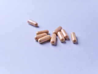 Ashwagandha (Withania somnifera) capsules. Paper background. Soft focus. Close up. Copy space.	