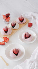 Japanese daifuku strawberry mochi filled with red bean paste in bright white background