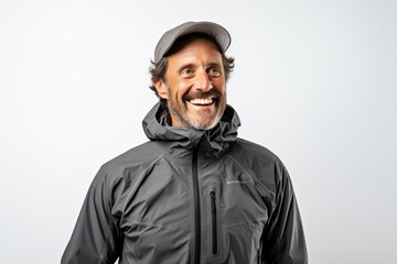Obraz premium Portrait of a happy man in his 40s wearing a windproof softshell while standing against white background