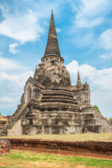 Fototapeta premium Big stupa in Wat Phra Si Sanphet ancient temple in Ayutthaya historical park, Thailand, Asia. Historical Buddhist architecture on archaelogical site in ancient capital of Siam. Vertical orientation
