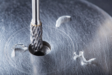 Milling cutter make sink in hole in steel billet. Locksmith work.