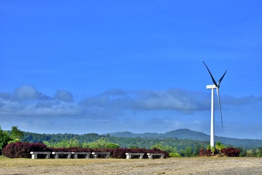 San Lorenzo, Guimaras, Philippines - June 12, 2022: Windmill with clear skies, producing renewable energy effortlessly.