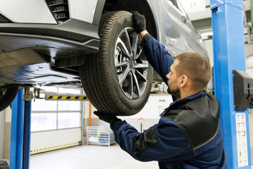 Auto car repair service center. Mechanic examining car