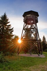 Wooden view tower in the forest in sunset light. © Tunatura