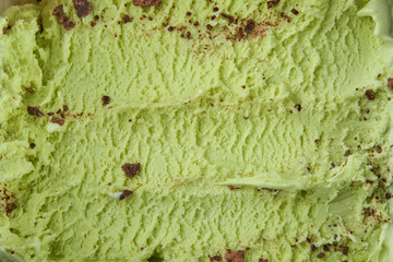 Pistachio ice cream detailed macro texture. Texture pistachio ice cream with chocolate chips. Top view. Food concept. Blank for design.