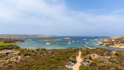 Aerial view of Cala Garibaldi on Caprera Island, Sardinia, showcasing anchored recreational boats...