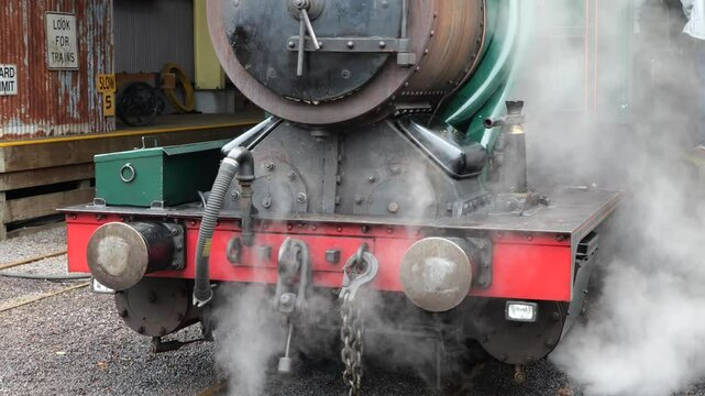  Steam train beeing filled with water for the next trip. Small and old steam powered locomotive. Old steamtrain waiting in the station. Old, ancient coal powered train ready to leave the station.