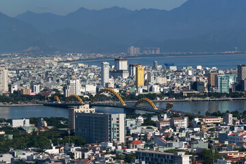 Obraz premium far view of dragon bridge in da nang. This modern bridge crosses the Han River at the Le Dinh Duong, Bach Dang traffic circle