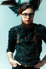 Fashion shot of a handsome young woman with a red beard and glasses.