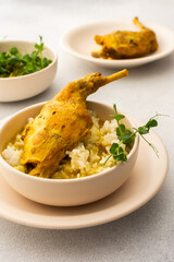 Stewed rabbit with rice, broccoli , served table with food, delicious hearty lunch or dinner