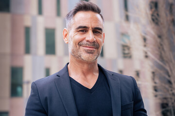 Obraz premium portrait of smiling businessman looking at camera outdoors.