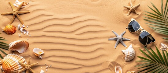 Naklejka premium Top view flat lay of sunglasses, seashells, and photo frames on a sandy background, ideal for travel vacation concept with available copy space image.