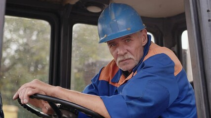 An exhausted construction worker taking a break and resting inside a vehicle cabin during the day