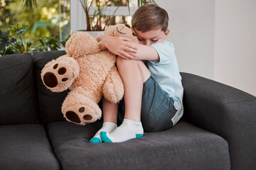 Sad, child and sofa with teddy bear at house for discipline conflict, family crisis and bullying...