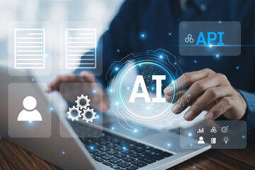 A businessman uses a computer to integrate Application Programming Interfaces (APIs), Artificial...