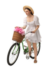 Beautiful young woman with bicycle and basket of peony flowers isolated on white