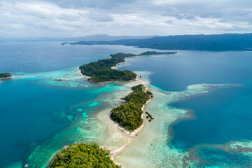 Aerial view of lush green islands surrounded by clear blue waters in the Philippines