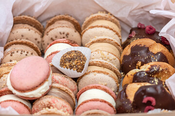 Sweet french delicious dessert macaroons on box background