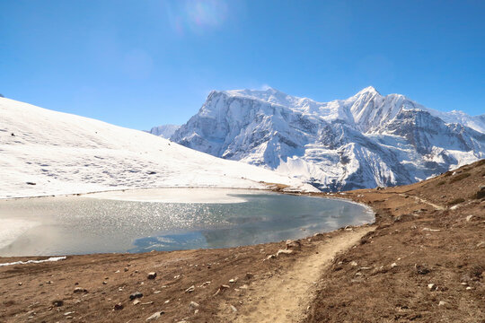 The Saano Khicho Lake in front Annapurna III, Gangapurna and Tarke Kang on a sunny day, next to the Ice Lake, Kicho Tal, Khicho Ice Lake, close to Manang, Annapurna Circuit Trek, Nepal