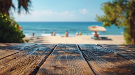 A wooden surface with a blurry background of a beach with people and an umbrella