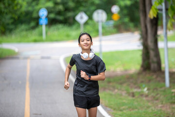 A girl jogs energetically during her holiday, savoring the crisp, fresh air and the vibrant landscape around her
