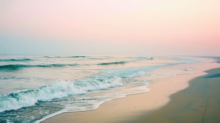 Gentle Waves Crashing on Sandy Beach at Sunrise