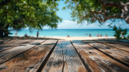 Obraz premium Weathered wooden planks in the foreground with a blurred background of a beach scene