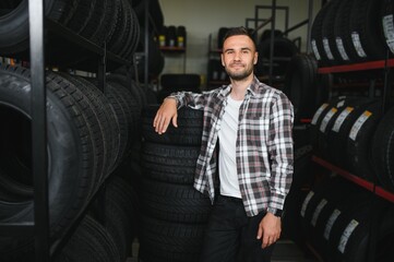 A young man buys new tires for his car