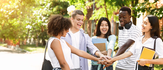 Education And Unity Concept. Group Of International Students Stacking Hands Together Outdoors In College Campus, Celebrating Success