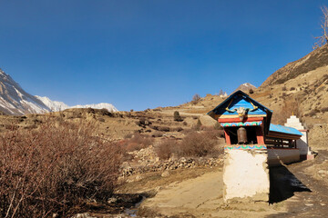 Prayer wheels in a desert like landscape, on the trail between Manang and Thorung, Thorung Phedi,...