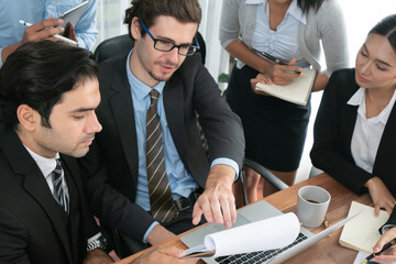 Diverse of business people from various ethnic group working in modern office environment. Productive and multi ethnic office workers engage in discussion for strategic business marketing. Habiliment