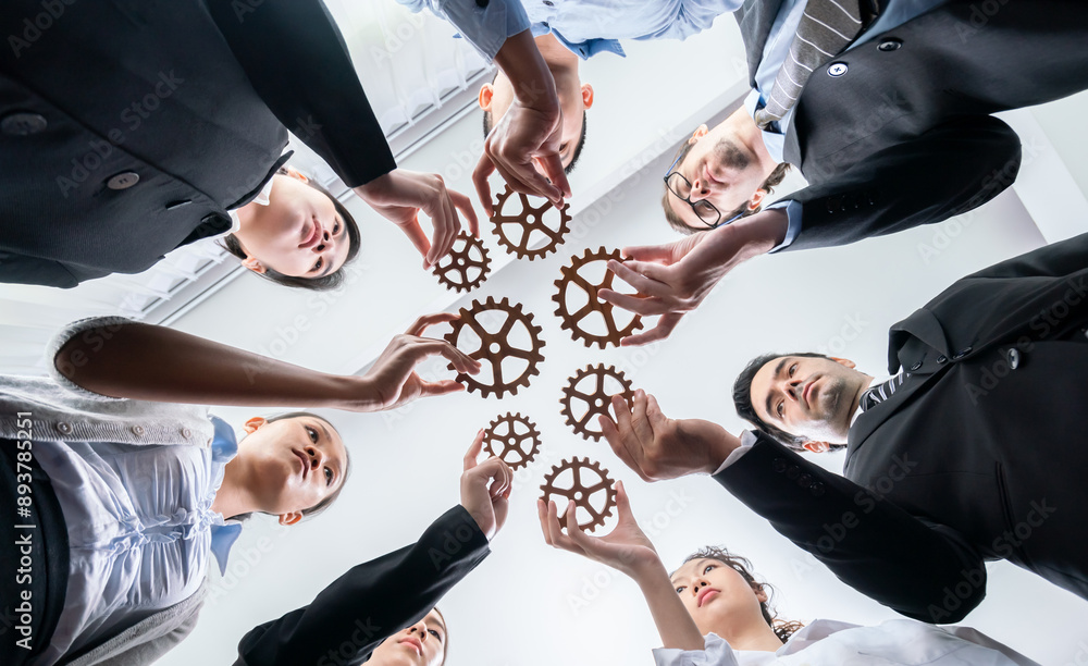 Poster below view group of multiracial business people joining gear wheels together as effective unity and 