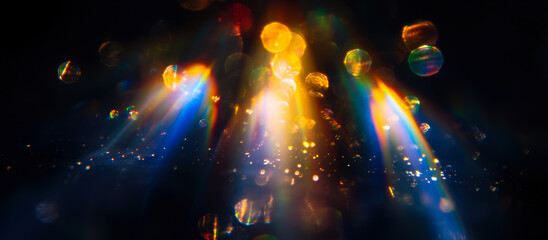 Vivid Abstract Bokeh Lights with Rainbow Lens Flare and Defocused Colorful Light Leaks on Black Background, Surreal and Dreamy Artistic Concept for Creative Designs or Digital Art Projects