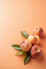 Peaches with leaves on a warm background.