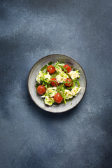Spinach cream puree with cherry tomatoes and arugula. Cold snacks. In a plate.