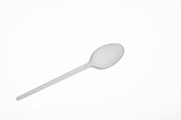 Disposable spoon. Plastic spoon. Disposable tableware.