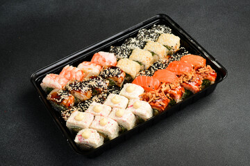 Japanese food. Set of sushi rolls with caviar, fish and shrimp. Food delivery. Free space for text.