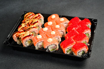 A box of sushi and rolls. Japanese food. Food delivery.